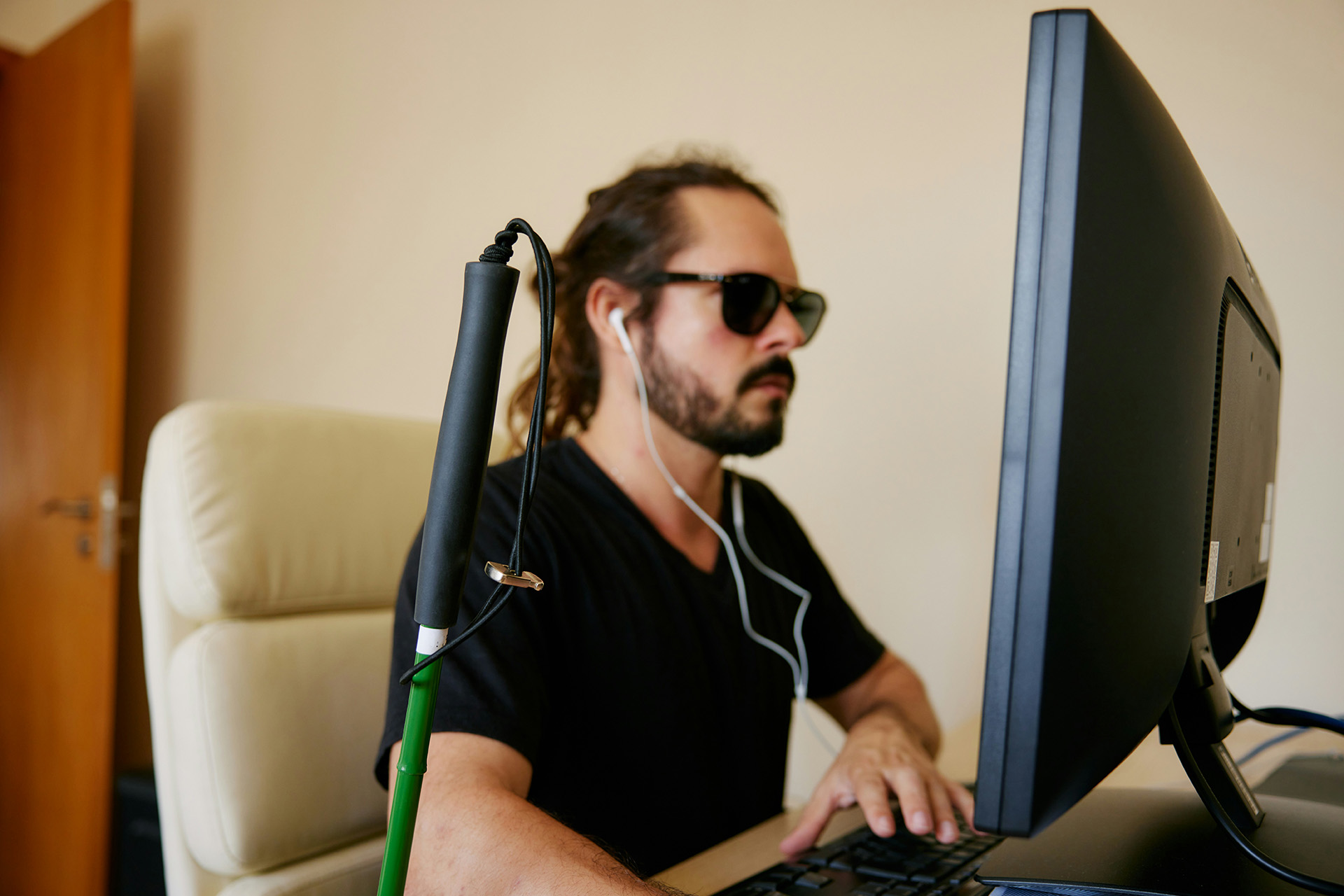 Blind man working at computer