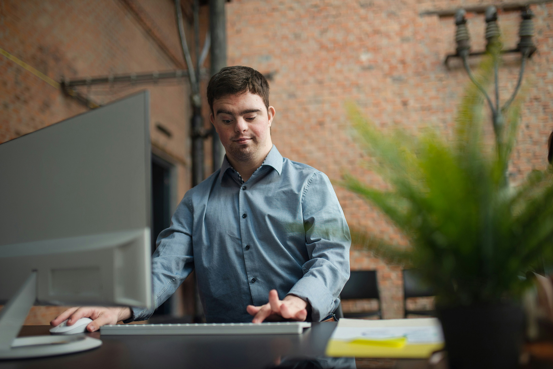 Blind man working at computer
