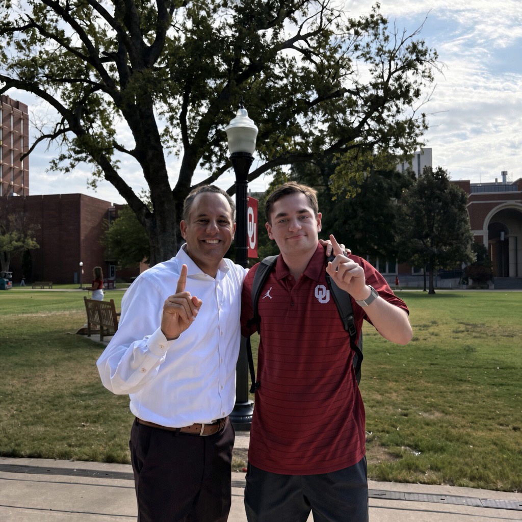 PYWSW1 OU president Beroz and a student standing together holding up index finger